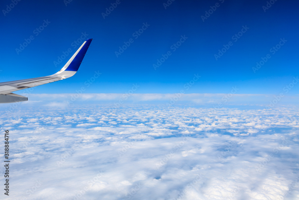 Airplane wing and beautiful blue sky with white clouds Airplane wing and beautiful blue sky with white clouds