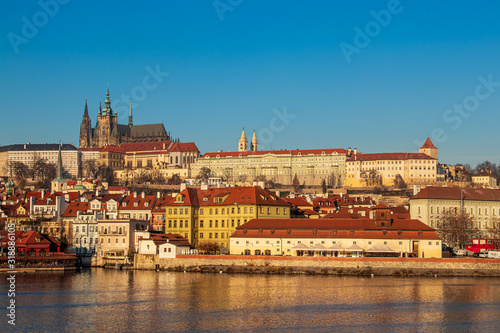 Sunlit Prague castle with buildings below