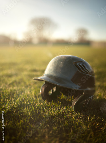 Baseball helmet in the grass at the ball park photo