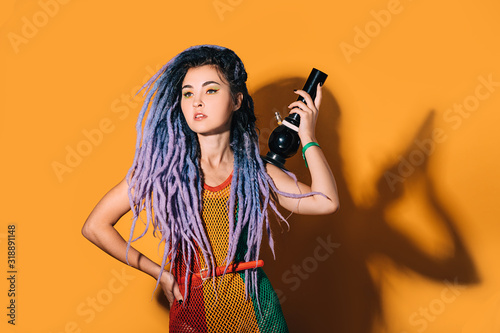 Photos Rasta woman holds a bong in her hand