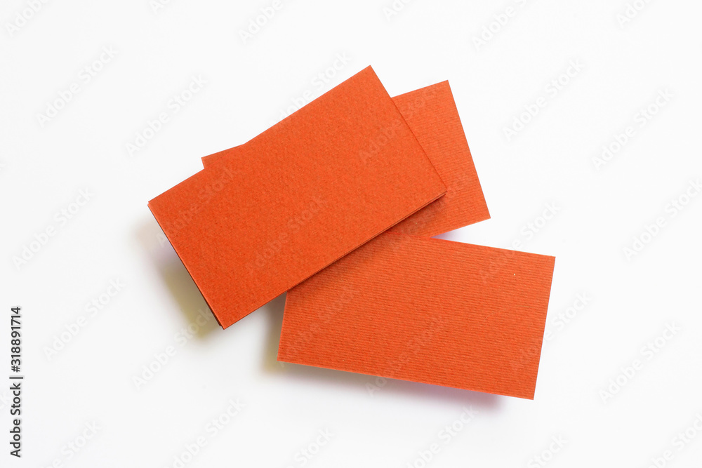 Three blank carrot color textured business cards isolated on white, composition concept for presentation, studio shot. Three blank carrot color textured business cards isolated on white, composition concept for presentation, studio shot.