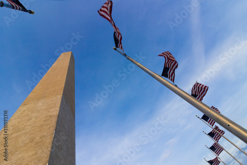 View of the Washington Monument with encircling American flagpoles and twilight skies above, the Mall, Washington DC photo