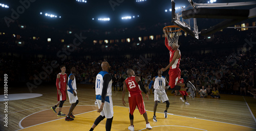 Basketball players on big professional arena during the game. Tense moment of the game. © haizon