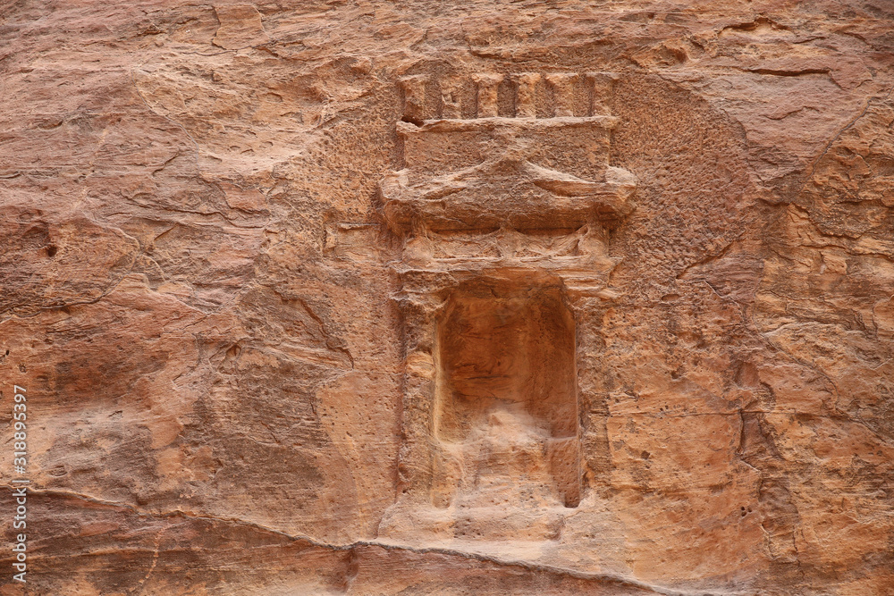 Carving in the sandstone cliffs of a window or entrance, Petra, Jordan.