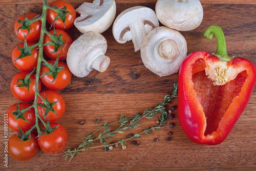 ripe tomatoes and other ingredients on dark wood baclkground photo