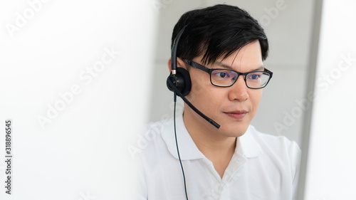 business background of caucasian male customer service agent on telephone service to customers at helpdesk call center