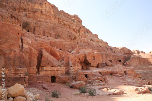 Street of Facades, which is caves with doors carved out of the red stone, Petra, Jordan.