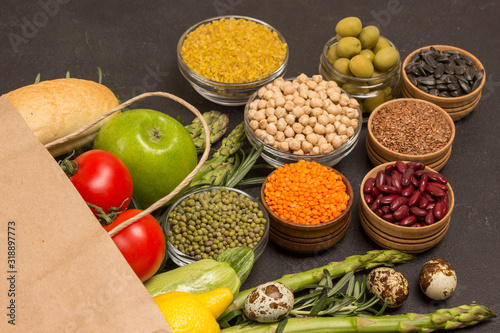 Healthy food for diet and lifestyle. Paper bag with vegetables, beans nuts, quinoa bulgur, chickpeas, flax