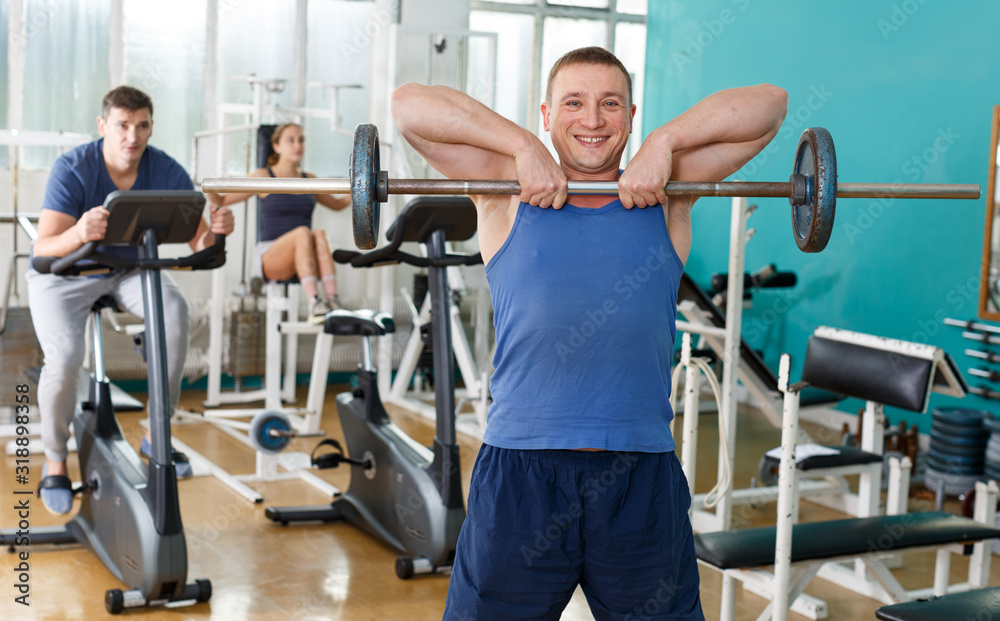 Man doing exercises with barbell