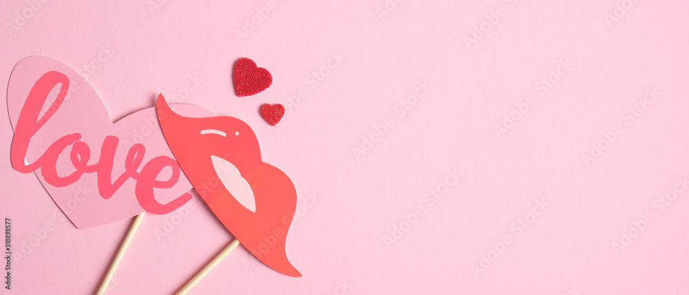 Minimalist Valentines Day banner template with Valentine's day props on pink background. Love and romance concept. Flat lay style composition, top view.