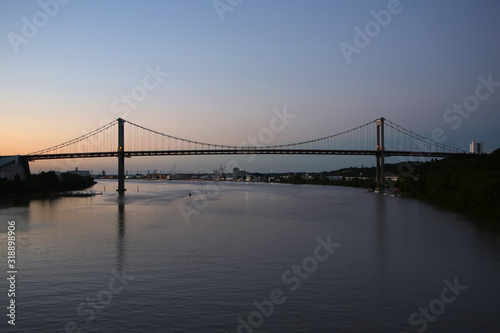 Pont d'Aquitaine bridge at sunset. It is a large suspension bridge over the Garonne, north-west of the city of Bordeaux, France.