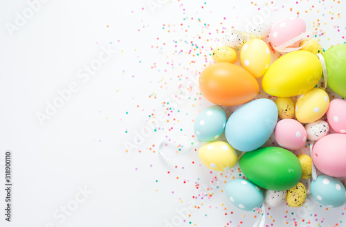 multi-colored bright easter eggs lie on a white background