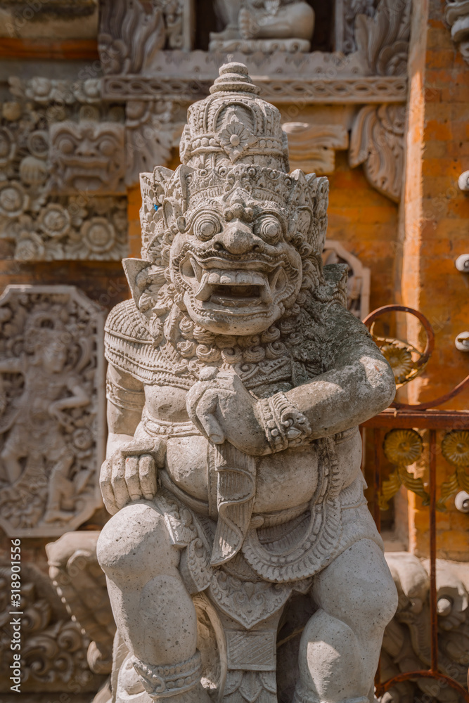 A traditional Balinese statue at the entrance to the gate of a Hindu temple in Central Ubud. Ubud Place. The most popular tourist destination in Ubud.