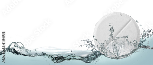 White tablet in spray of water.