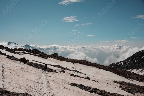 Tourist walks across the icy mountain plateau photo