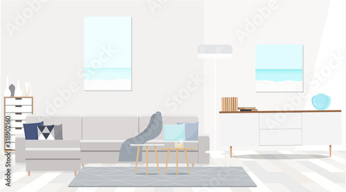 Grey corner sofa in fashionable white interior of the living room.