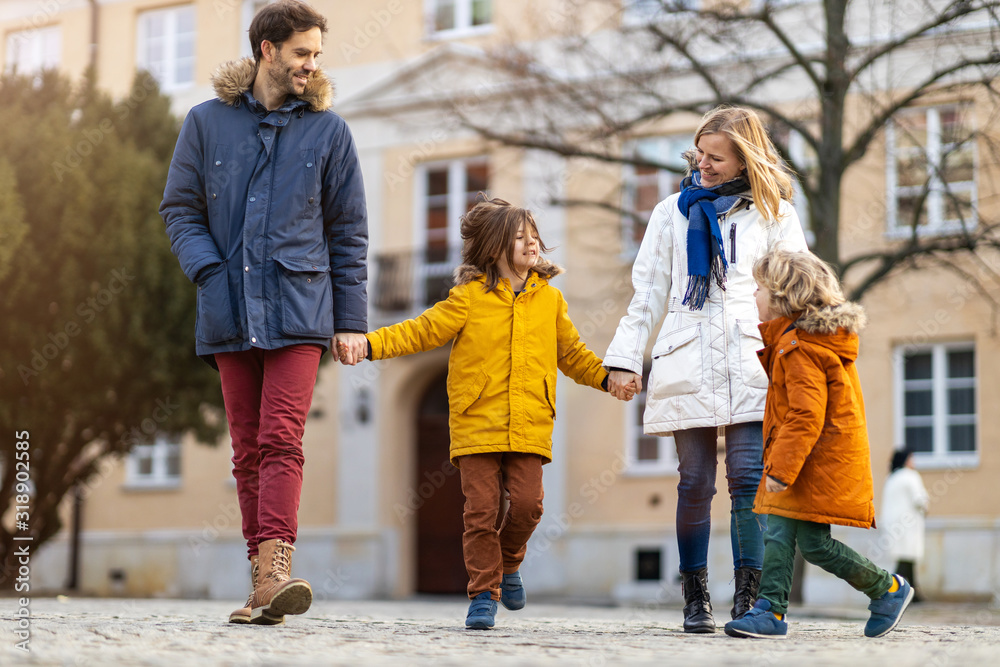 Affectionate young family enjoying their day in a city Affectionate young family enjoying their day in a city