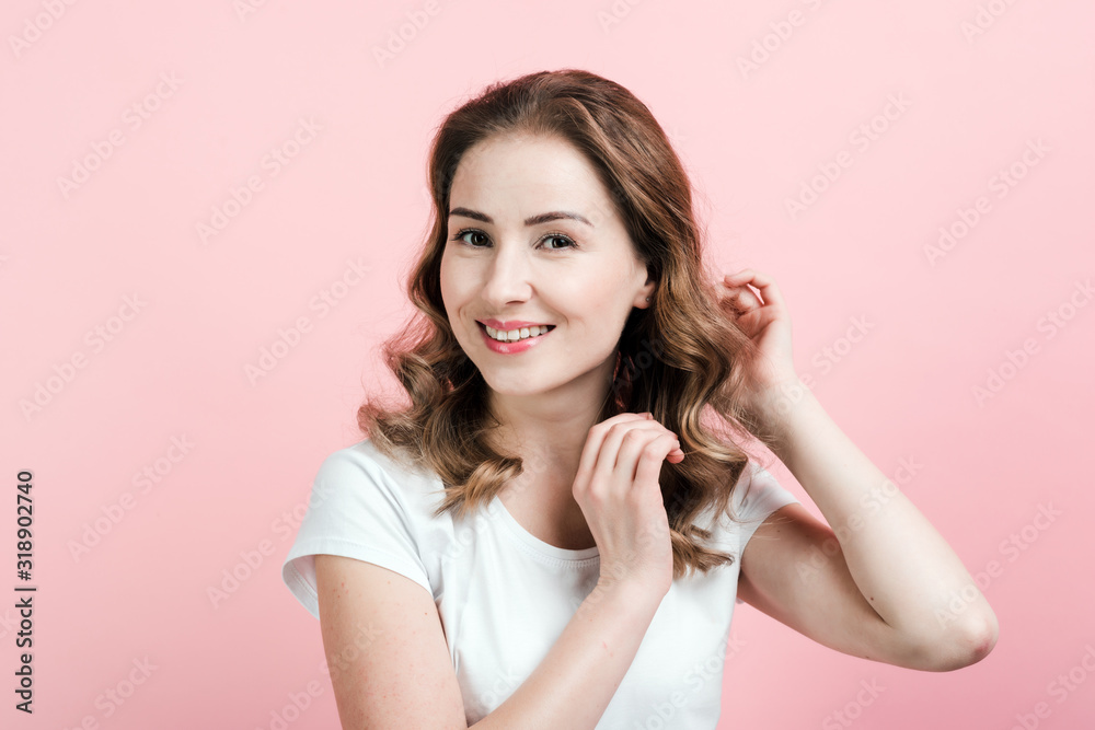 Indoor portrait of excited curly woman . Young lady smiling on pink background. Indoor portrait of excited curly woman . Young lady smiling on pink background.