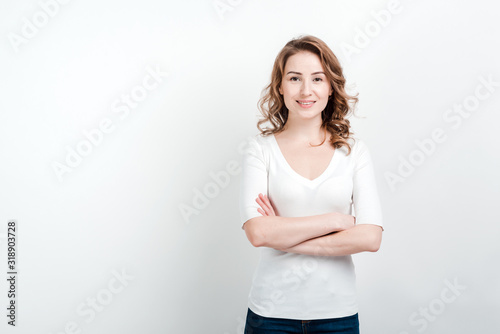 Portrait of woman   standing against a studio background folded her hands © speed300