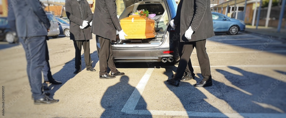 Gravediggers put coffin into car Gravediggers put coffin into car
