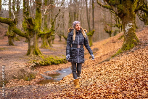 Very happy blonde girl in a beautiful forest walking © unai