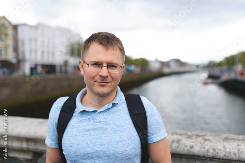 Photography portrait of man in glasses on bridge