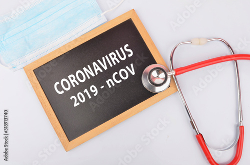 Text phrase Coronavirus on blackboard with medical equipment on white background. Novel coronavirus 2019-nCoV middle East respiratory syndrome coronavirus.