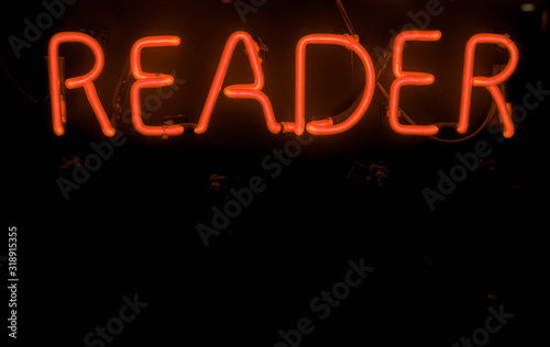 red reader neon sign with black copy space