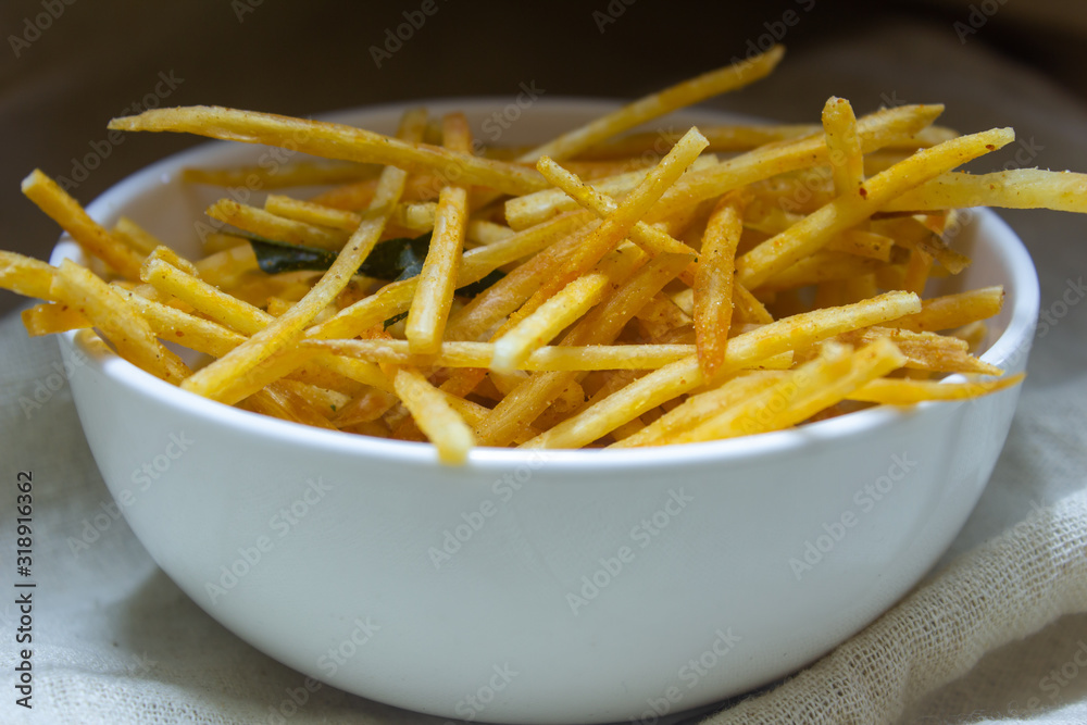 Bowl of crunchy tapioca needle chips which is a famous indian savoury. Crispy tapioca sticks with spices. Bowl of crunchy tapioca needle chips which is a famous indian savoury. Crispy tapioca sticks with spices.