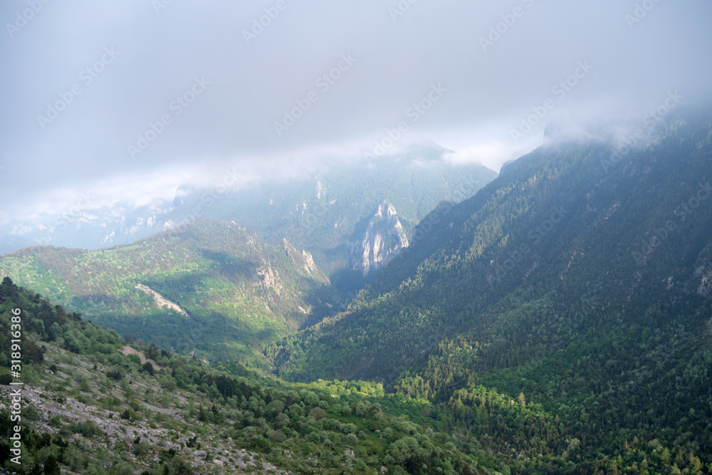 Fototapeta premium Fog revealing the mountain range, Ligurian Alps, northwestern Italy