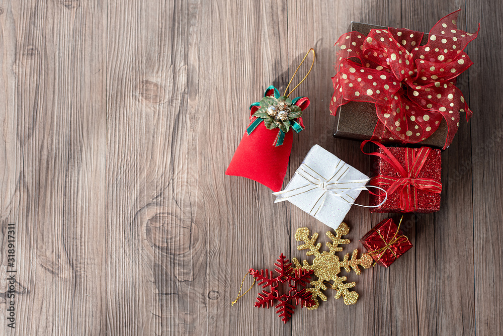 Flat lay of gift box and decoration object on wood background. Christmas and celebrations concept.