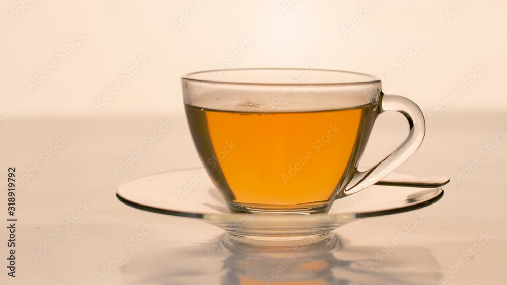 Close-up pouring the tea into a clear glass Close-up pouring the tea into a clear glass