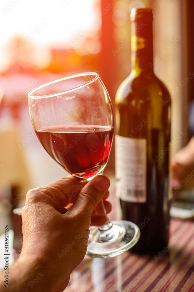 romantic dinner at sunset, red wine on the table romantic dinner at sunset, red wine on the table