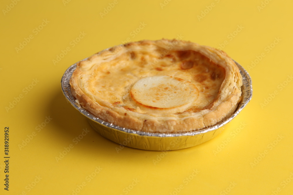 Delicious three cheese quiche in colored background Delicious three cheese quiche in colored background