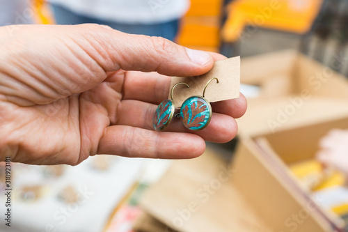 Closeup of handmade jewellery and accessories showcased on stalls. Original items sold by local craftsmen and designers on a crafts and arts outdoor market in Chisinau, Moldova