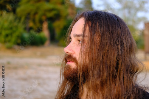 Photos Portrait of handsome bearded young man with long hair