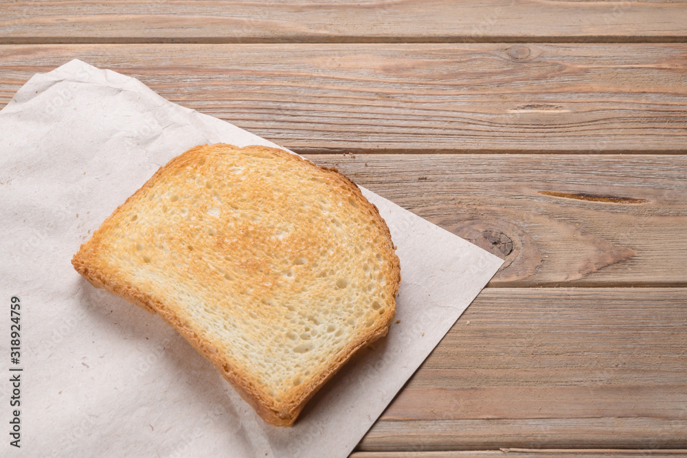 View of a white toast on wooden background View of a white toast on wooden background