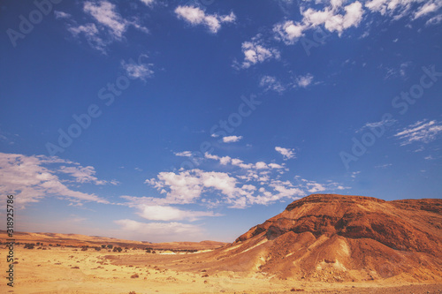 Mountainous desert with cloudy sky. Desert on a sunny day