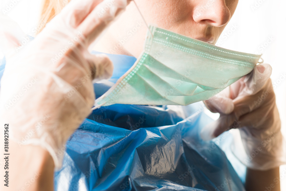 a woman wearing a hygiene mask and gloves is trying to avoid a coronavirus epidemic