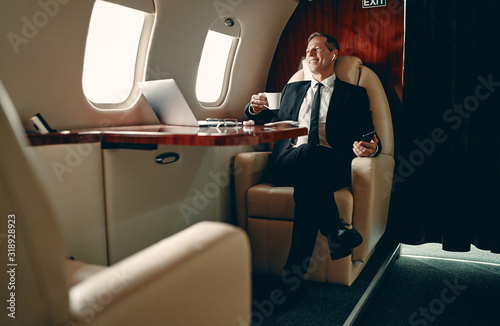 Businessman in private jet photo