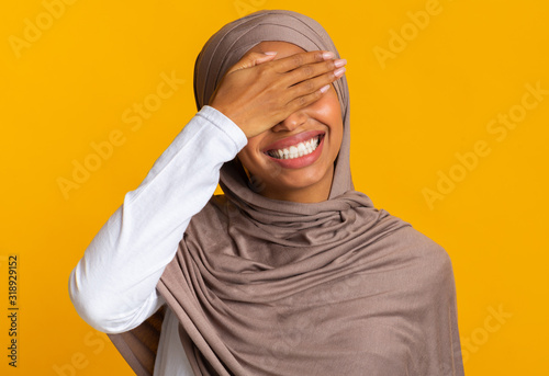 Facepalm. Cheerful Black Muslim Woman In Headscarf Covering Eyes With Hand © Prostock-studio