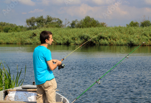 Young man fishing on the lake