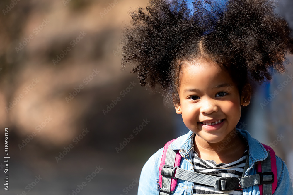 Happy little smiling African girl having fun at the part outdoor for back to school... Happy little smiling African girl having fun at the part outdoor for back to school...