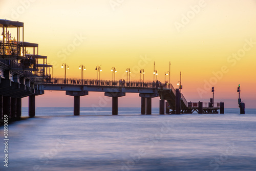Fototapeta Naklejka Na Ścianę i Meble -  Baltic sea at beautiful sunset in Miedzyzdroje beach. Polish baltic coast. Famous city among the tourist. Pier at sunset