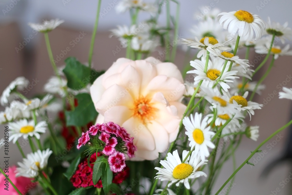 Fototapeta premium Handpicked flowers from a garden, arranged in a vase. Selective focus.