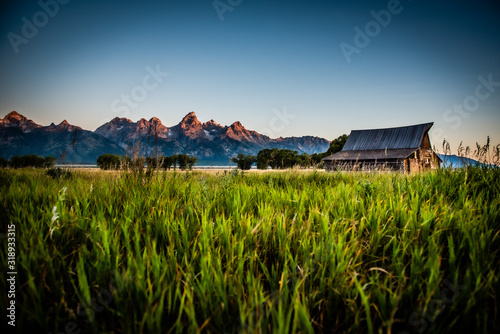 Sunrise with mountains and old barn photo