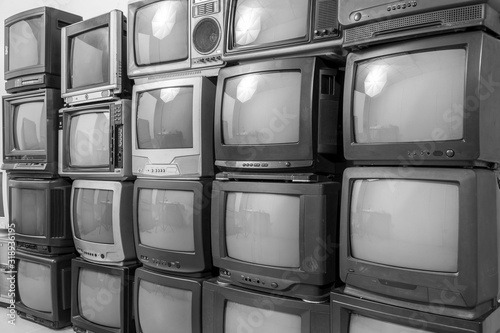 Black and white stack of old tv. Retro old television pile background.
