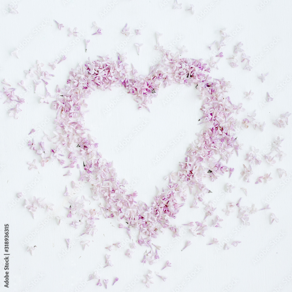Composition of flowers. Heart symbol of purple lilac flowers. Top view, flat lay