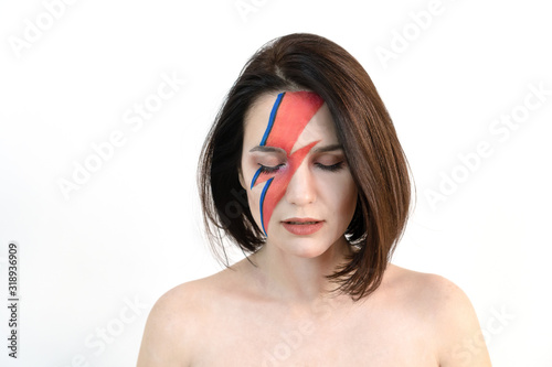 Tablou pe pânză Young beautiful girl with original make-up on her face looks down