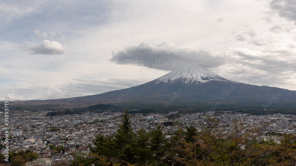 Snowcapped and cloud hat phenomena against the most beautiful volcano of the world Mt. Fuji with Kawaguchigo city .